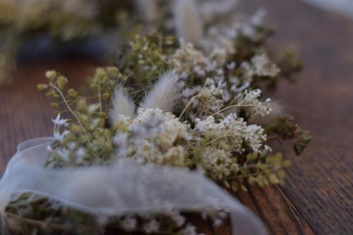 Green and white dried flower wreath close up